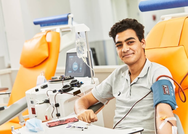 Donor in a plasma donation center 768x545